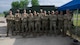 A group of Airmen from the 5th Force Support squadron pose in front of the expandable single pallet expeditionary kitchen (espek) at Fargo Air National Guard Base, North Dakota, May 31, 2026. The espek provides safe climate-controlled environments for food prep, cooking, and serving Airmen while in a deployed environment.