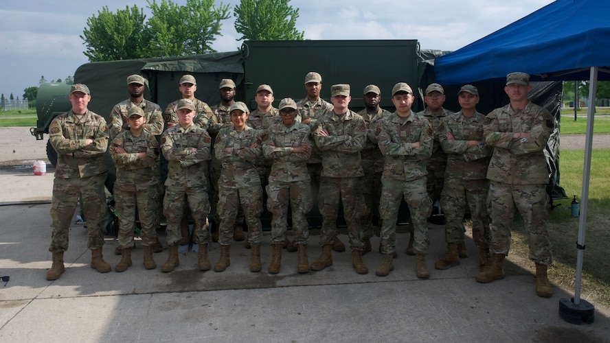 A group of Airmen from the 5th Force Support squadron pose in front of the expandable single pallet expeditionary kitchen (espek) at Fargo Air National Guard Base, North Dakota, May 31, 2026. The espek provides safe climate-controlled environments for food prep, cooking, and serving Airmen while in a deployed environment.