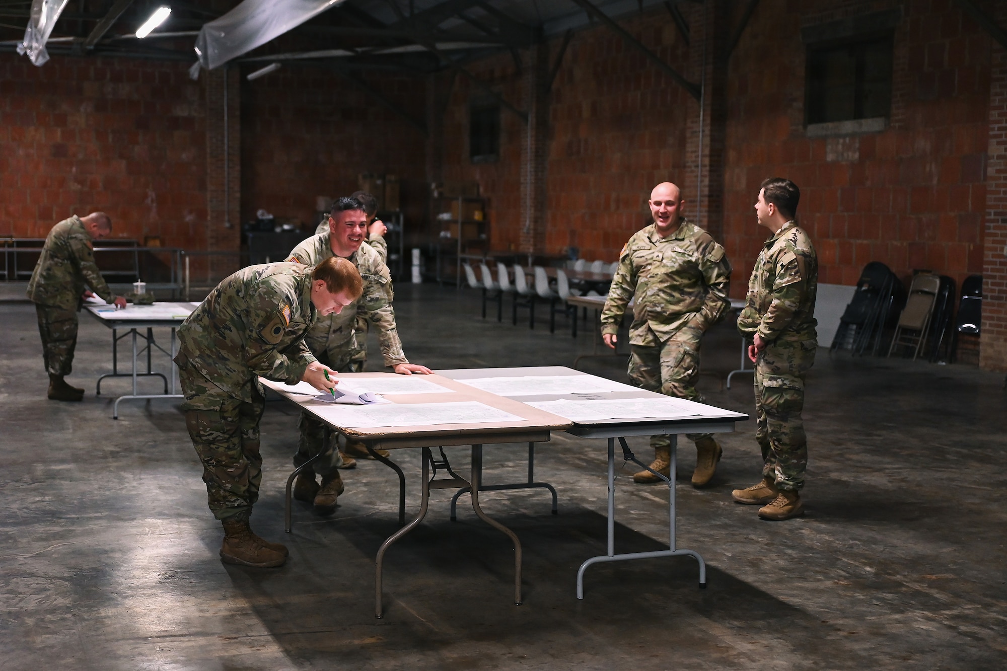 A chaplain determines distance on a map during land navigation training April 25, 2026 at Camp Garfield in Ravenna, Ohio. The training ensures that the chaplains and their religious support teams can read maps and navigate in the event they become separated from their unit. (U.S. Air National Guard photo by Shane Hughes)
