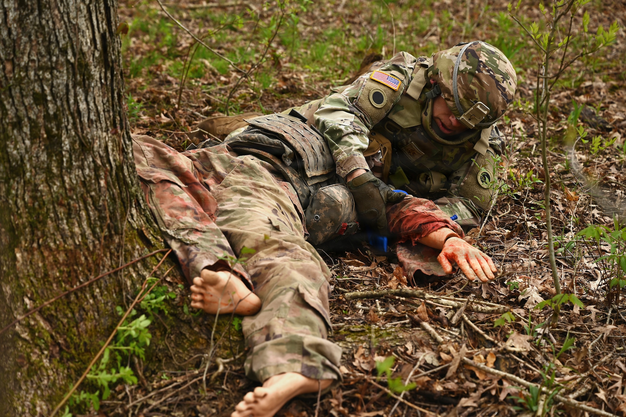 U.S. Army Maj. Shane Bailey, a chaplain assigned to Ohio National Guard Joint Force Headquarters, provides combat casualty care under fire during large-scale combat operations training April 25, 2026 at Camp Garfield in Ravenna, Ohio. The training included more than 45 chaplains from the Ohio National Guard, Ohio Militia, and Serbian Defense Forces. (U.S. Air National Guard photo by Shane Hughes)