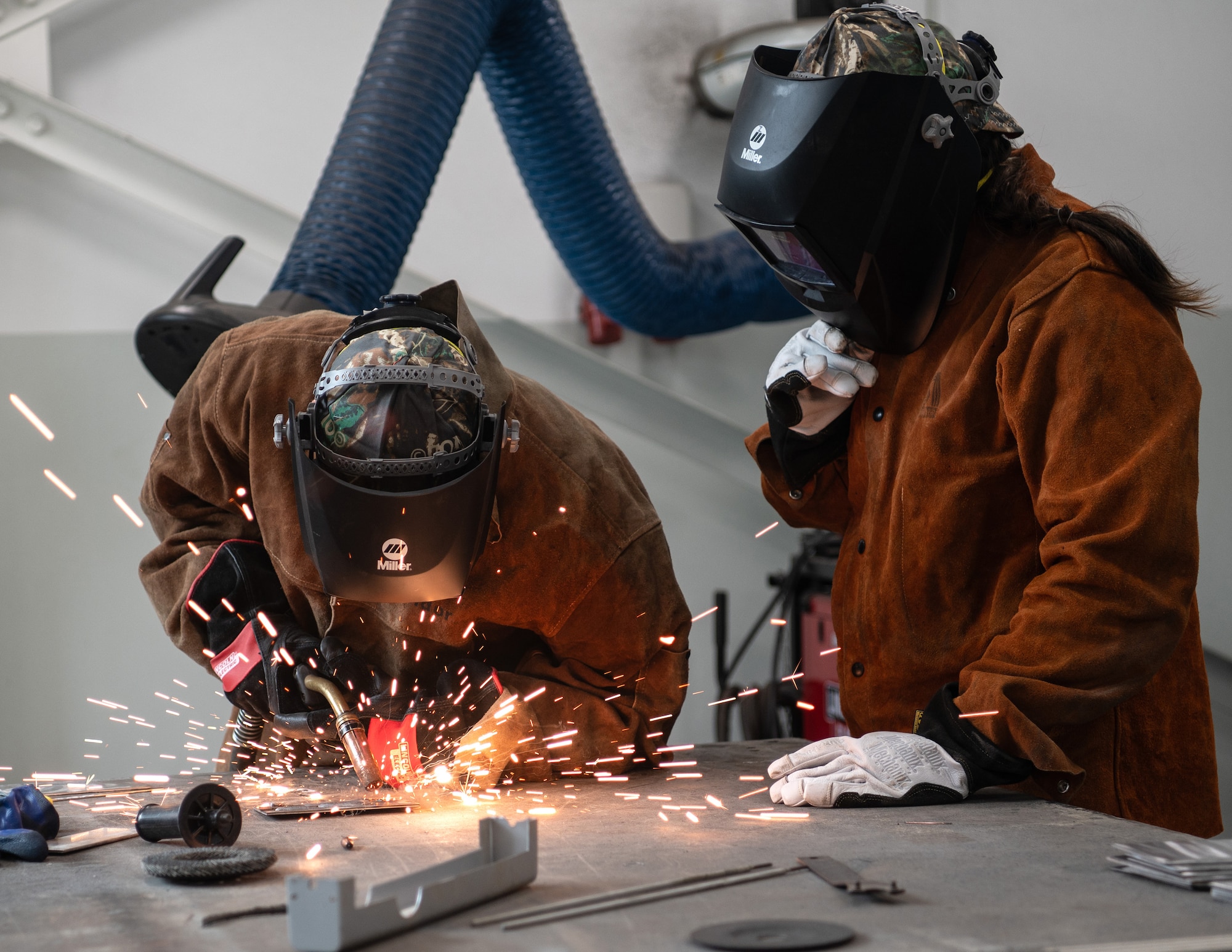U.S. Air Force Airman 1st Class William Henry, left, and Staff Sgt. Amanda Wolkenhauer, right, 133rd Civil Engineer Squadron, practice metal inert gas welding during base sustainment operations at Lajes Field, Azores, Portugal, May 13, 2026.