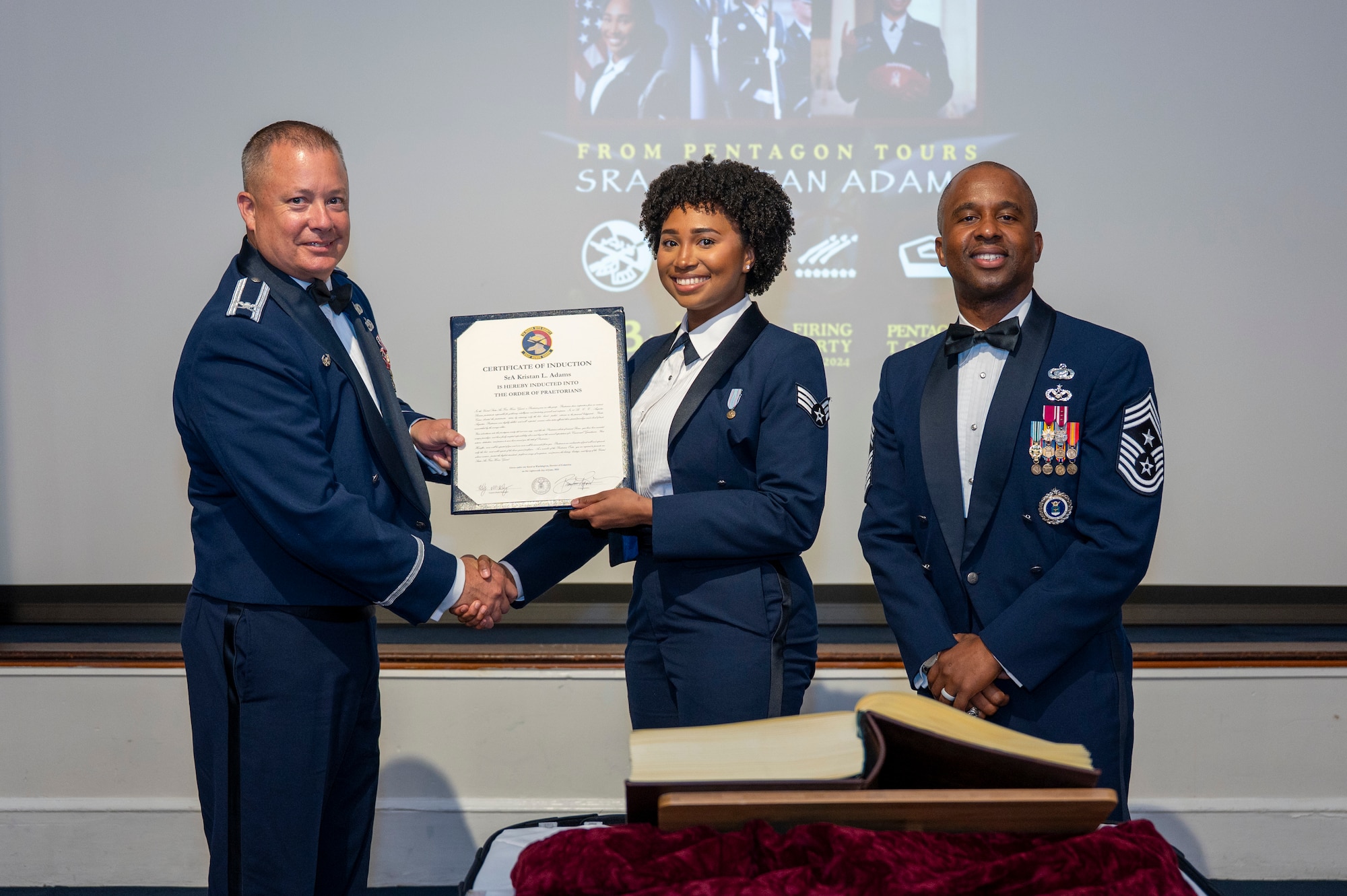 U.S. Air Force Col. James M. Clark and Chief Master Sgt. Anthony Thompson Jr. present an Order of the Praetorian
certificate to Senior Airman Kristan Adams.