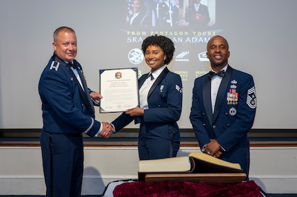 U.S. Air Force Col. James M. Clark and Chief Master Sgt. Anthony Thompson Jr. present an Order of the Praetorian
certificate to Senior Airman Kristan Adams.