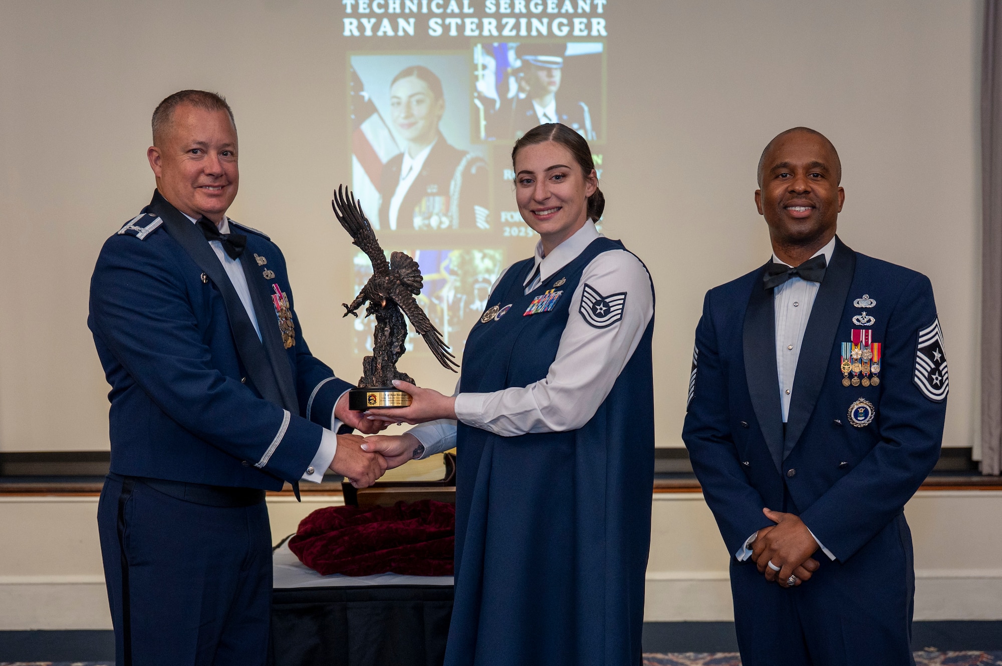 U.S. Air Force Col. James M. Clark and Chief Master Sgt. Anthony Thompson Jr. present the Ceremonial Guardsman of
the Year Award in the noncommissioned officer category to Tech. Sgt. Ryan Sterzinger.