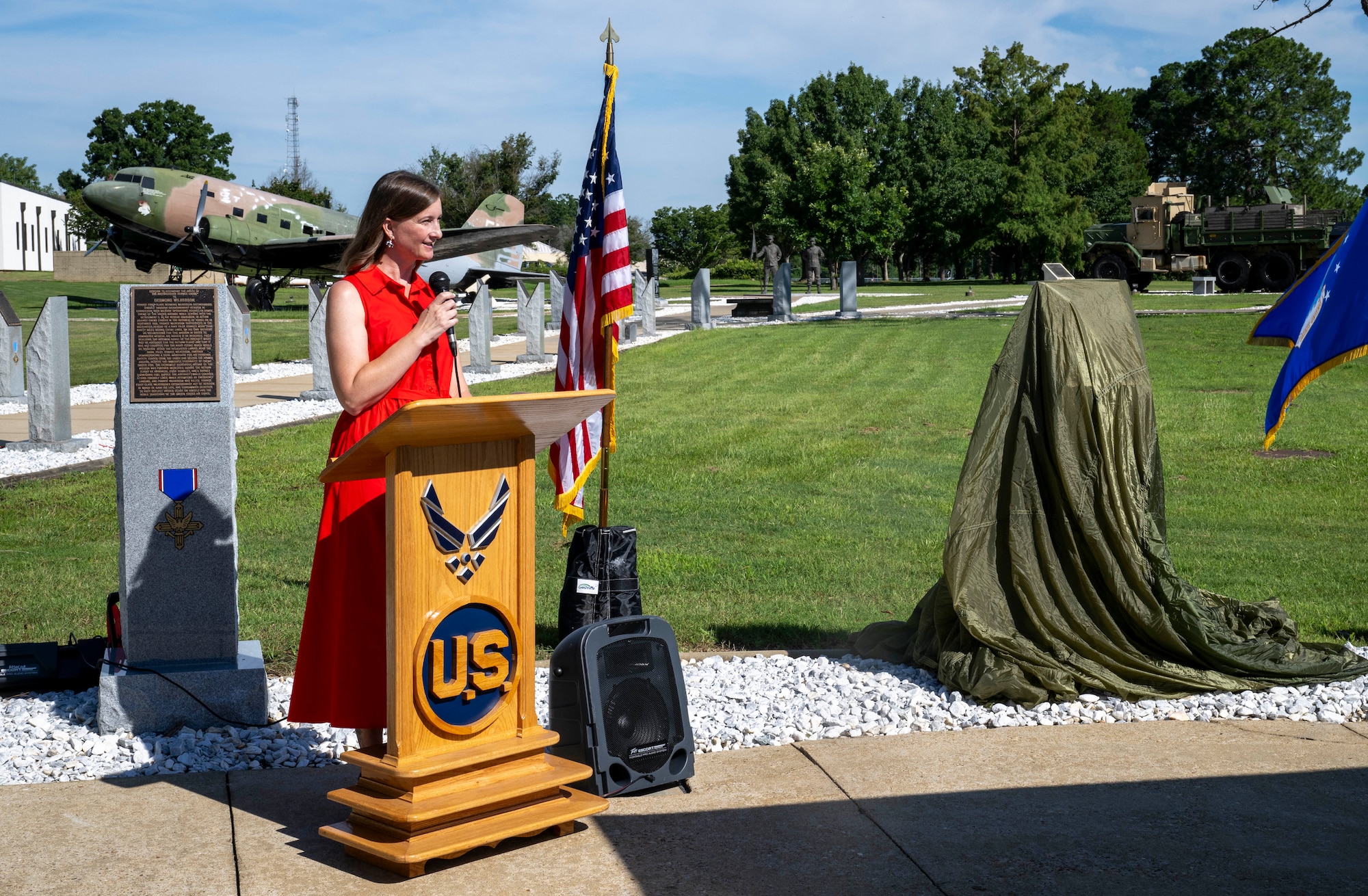 Melissa Sims, Air Force Enlisted Heritage Research Institute curator, delivers opening remarks during the monument dedication ceremony for Tech. Sgt. James H. Ledford at the Enlisted Heritage Hall’s Walk of Heroes, June 24, 2026. (U.S. Air Force photo by Brian Ferguson)