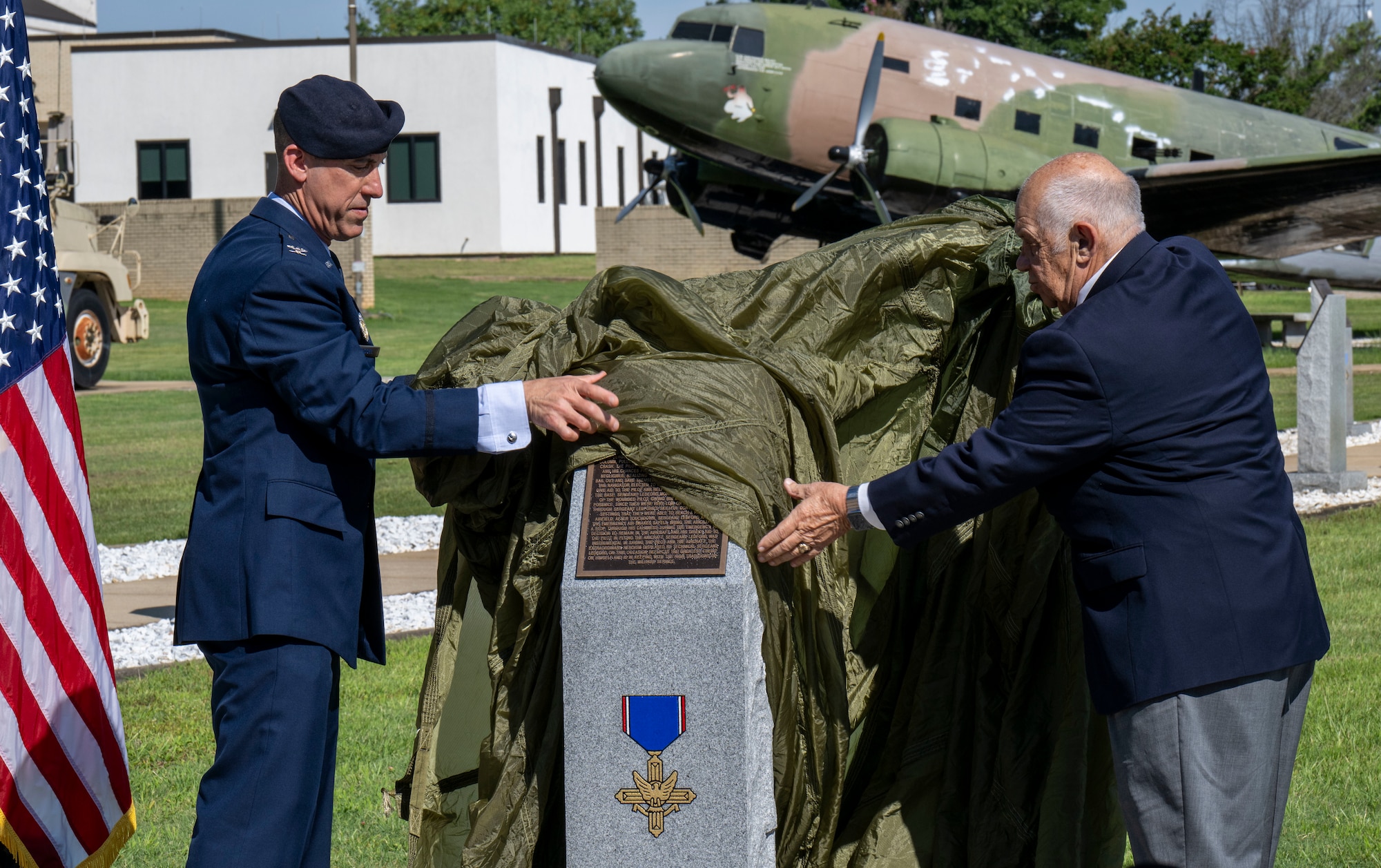 Col. Damian Schlussel, director of Air Force Security Forces and representative of the Schlussel Family Foundation, and retired Col. Joe Panza, executive director of the Air University Foundation, unveil a monument dedicated to Tech. Sgt. James H. Ledford at the Walk of Heroes, June 24, 2026. The Schlussel Family Foundation sponsored the creation of the monument. (U.S. Air Force photo by Brian Ferguson)