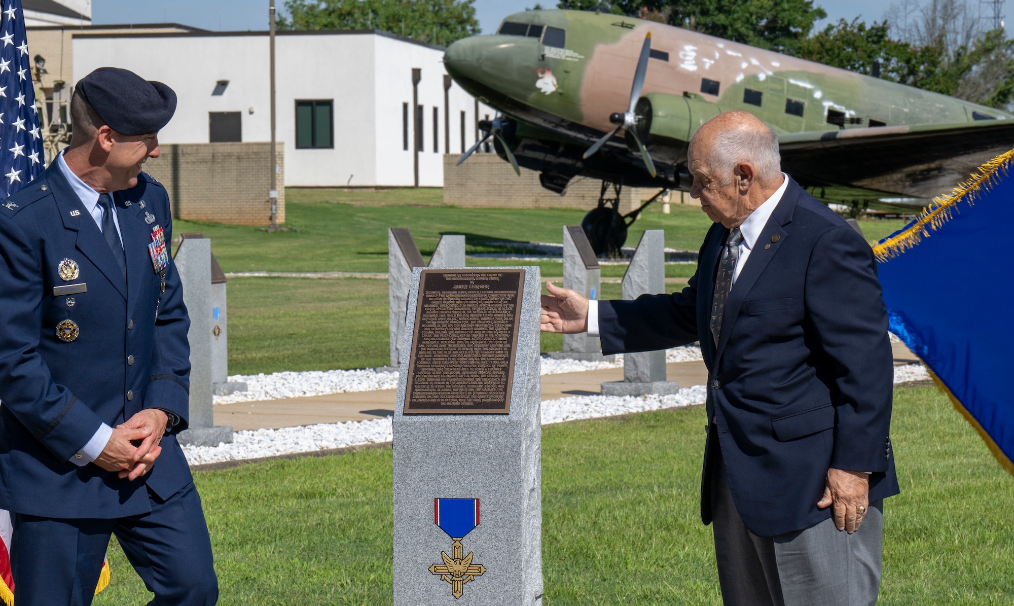Col. Damian Schlussel, director of Air Force Security Forces and representative of the Schlussel Family Foundation, and retired Col. Joe Panza, executive director of the Air University Foundation, unveil a monument dedicated to Tech. Sgt. James H. Ledford at the Walk of Heroes, June 24, 2026. The Schlussel Family Foundation sponsored the creation of the monument. (U.S. Air Force photo by Brian Ferguson)