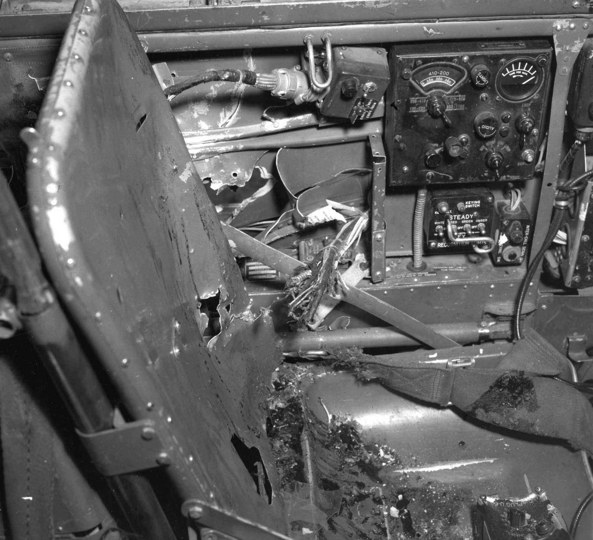 This historical photo shows the interior damage to the cockpit of a B-26 Invader after it was struck by an anti-aircraft shell over North Korea, Dec. 8, 1952. The blast severely wounded the pilot, visible by the damage to the seat, prompting Tech. Sgt. James H. Ledford to take control of the aircraft and avert a catastrophic crash. (U.S. Air Force photo)