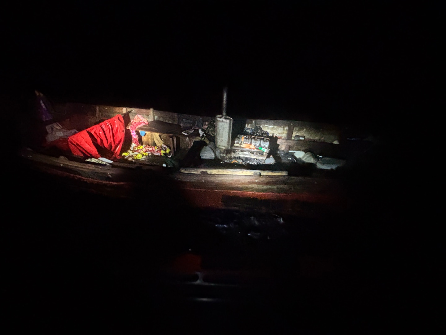 A Coast Guard Cutter Raymond Evans small boat crew approaches an unlit vessel in the Yucatán Channel, June 18, 2026. The crew discovered the vessel was taking on water, had no fuel or water aboard, and embarked 27 Cuban aliens, who were later transferred to Coast Guard Cutter Winslow Griesser for repatriation to Cuba. (U.S. Coast Guard photo by Coast Guard Cutter Raymond Evans)