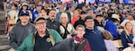 A group of fans in the stands at an LA Dodgers baseball game.