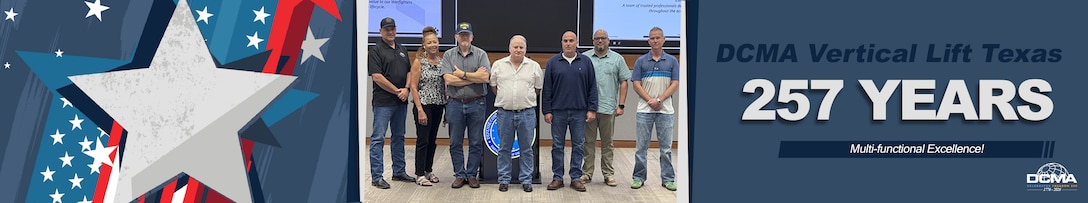 A group poses for a photo in a conference room
