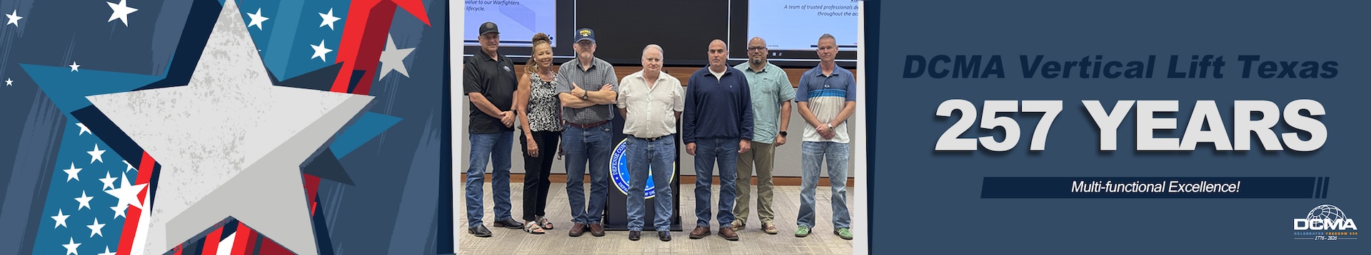 A group poses for a photo in a conference room