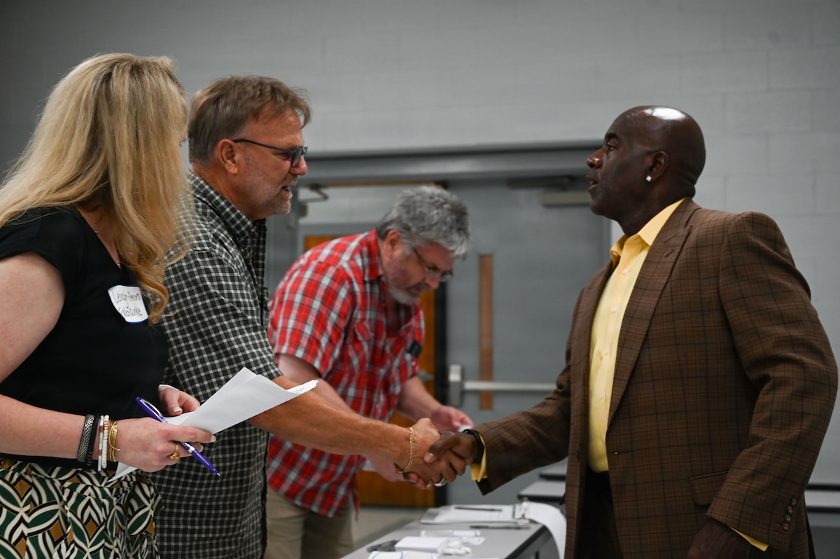 Two men shake hands