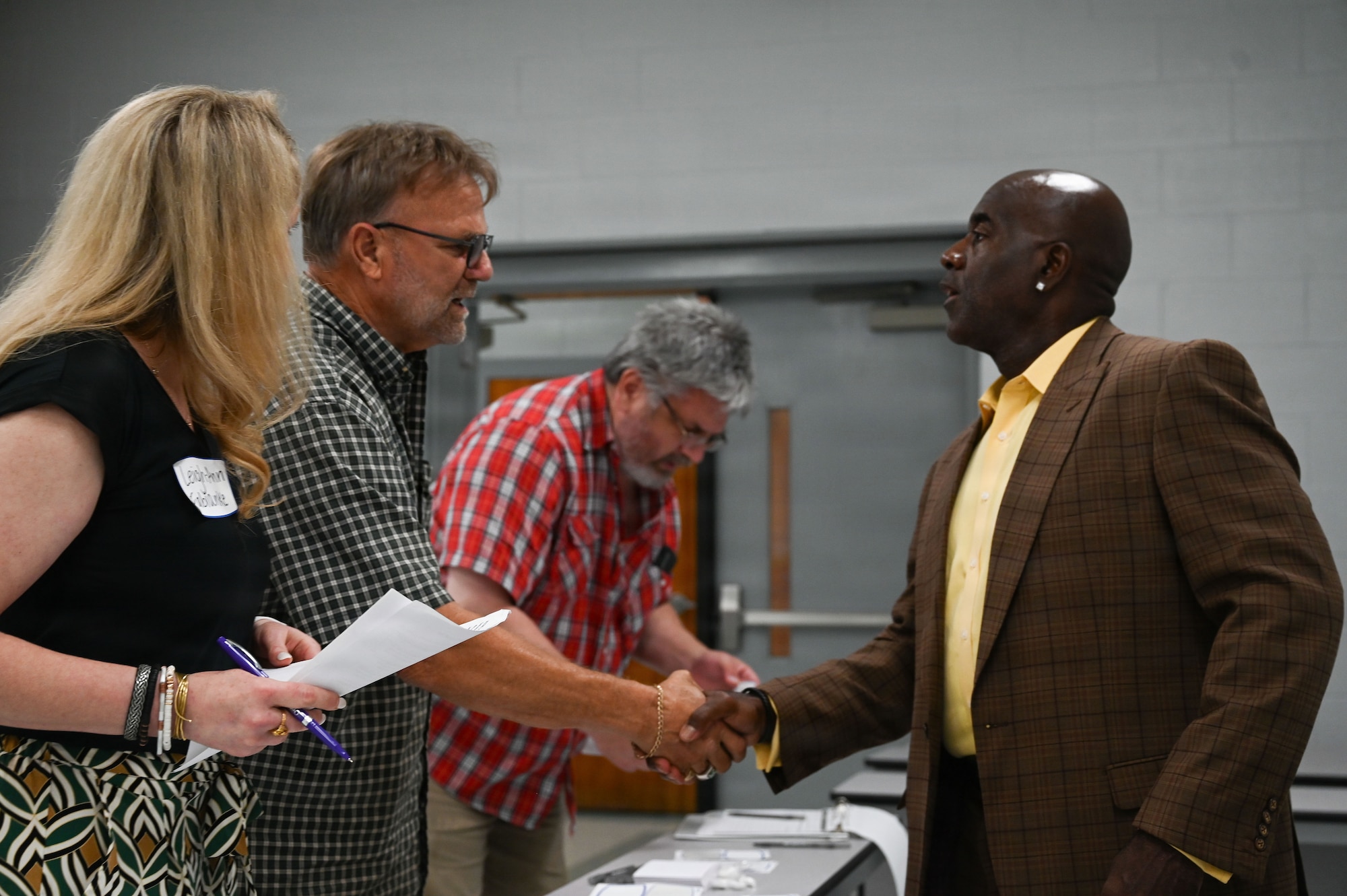 Two men shake hands