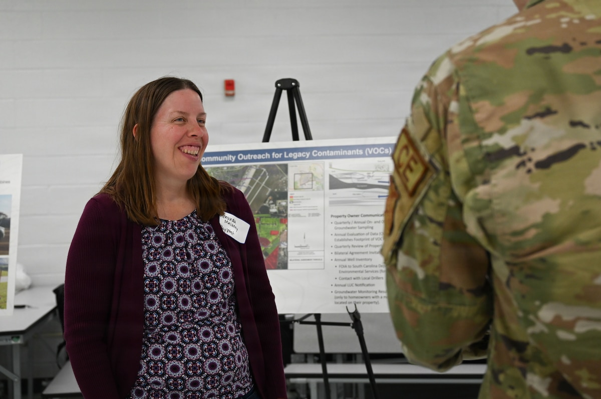 A civilian speaks to an Airman