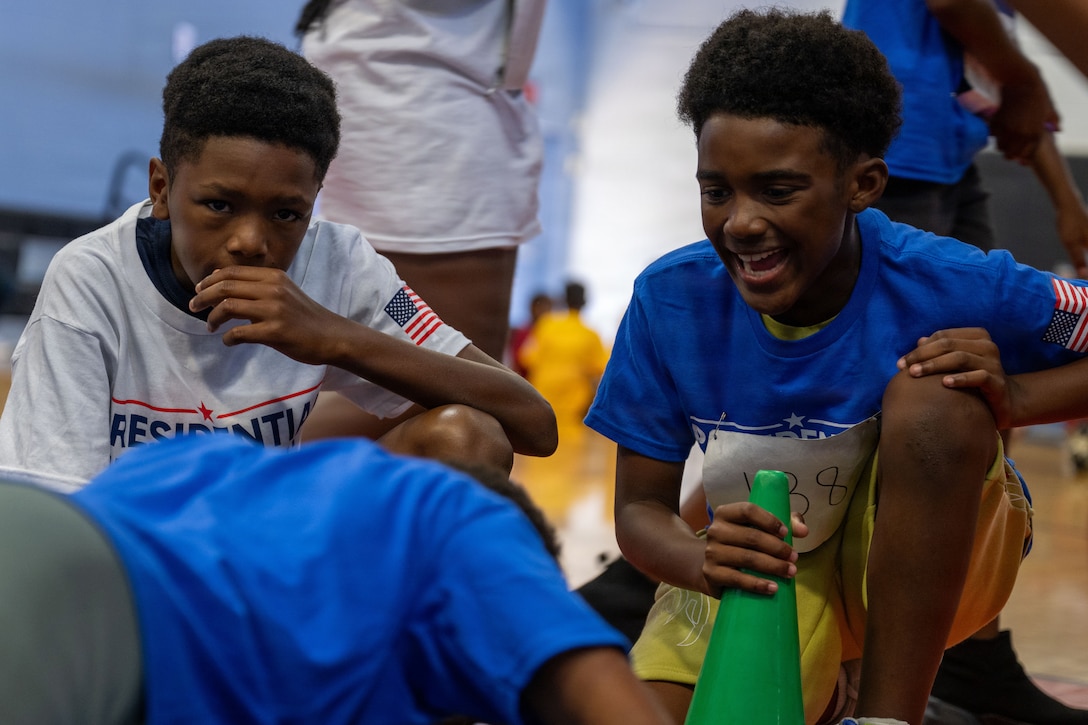 Students from the Joint Base Andrews Youth Center cheer on a fellow student during the Presidential Fitness Test.