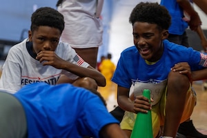 Students from the Joint Base Andrews Youth Center cheer on a fellow student during the Presidential Fitness Test.