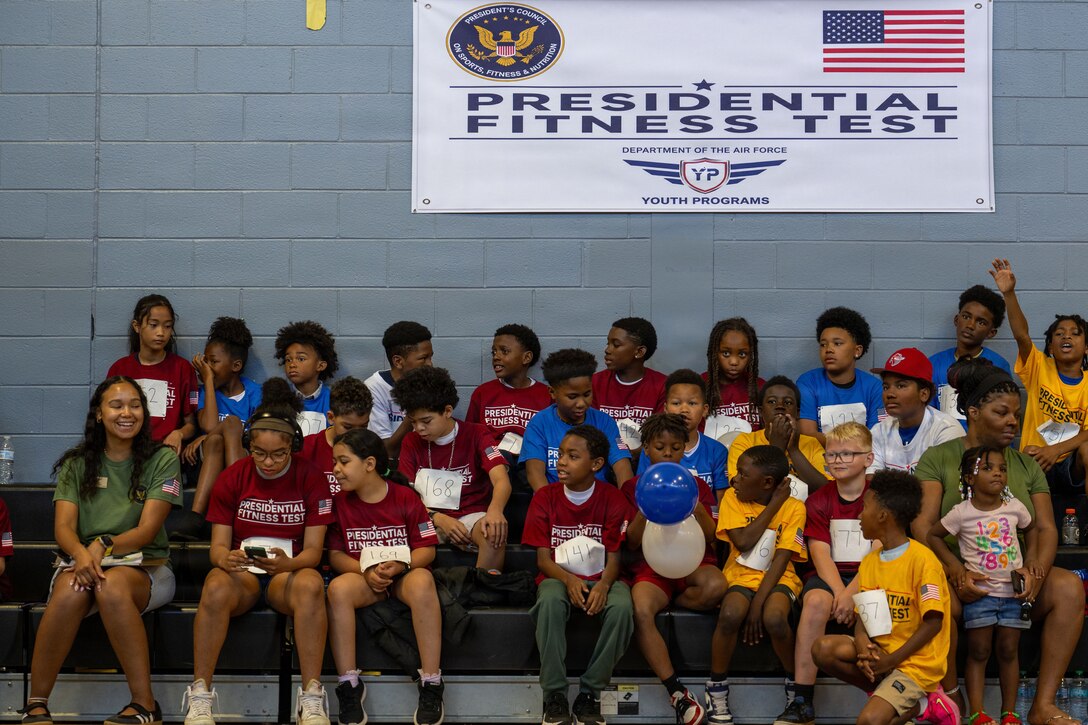 Students from the Joint Base Andrews Youth Center socialize before the Presidential Fitness Test at Joint Base Andrews.