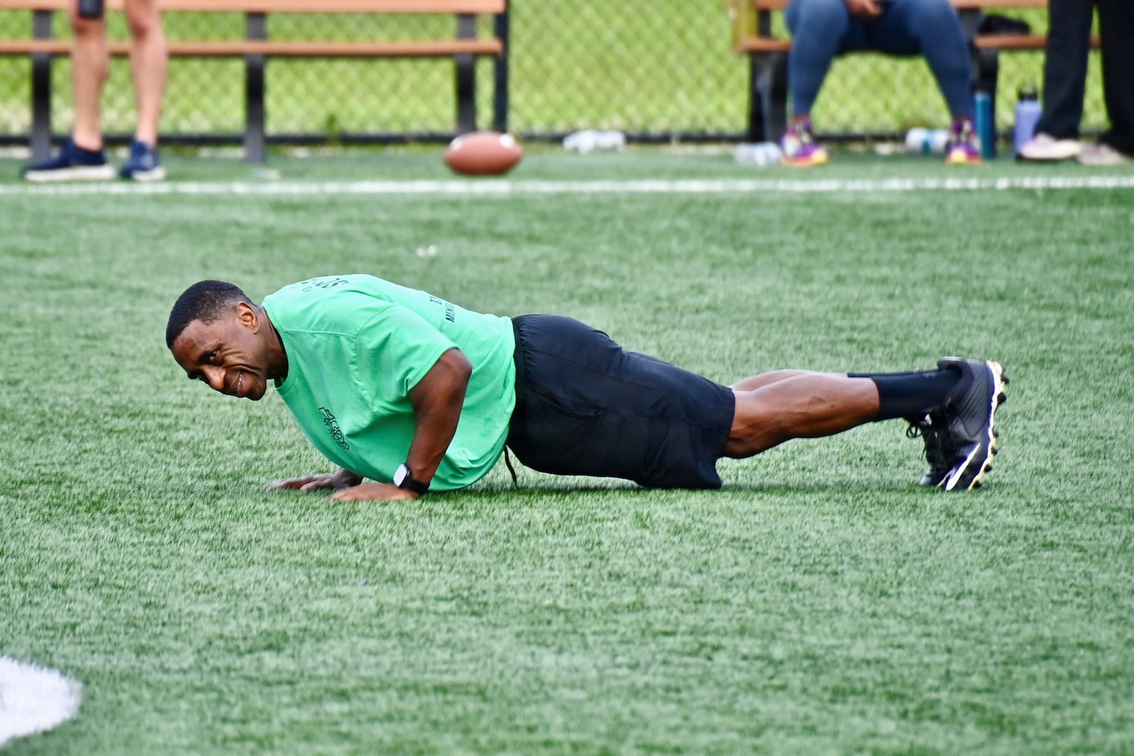 A BJACH Soldier does pushups during a football game on Anvil Field.