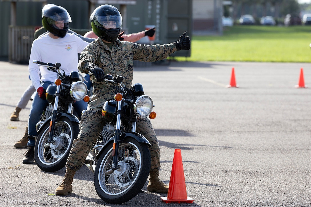U.S. Marine Corps Sgt. Bryan McDougal, a supply quality assurance specialist for Blount Island Command, signals a thumbs up during a basic rider course June 25, 2026, at Marine Corps Support Facility Blount Island, Florida. The two-day course equipped novice riders with classroom instruction and hands-on training to develop rider proficiency and promote motorcycle safety. (Marine Corps photo by Dustin Senger)