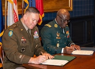 U.S. Army Maj. Gen. John R. Pippy, adjutant general of the Pennsylvania National Guard and Chief of the General Staff of the Côte d'Ivoire Armed Forces Gen. Lassina Doumbia sign the official Department of War National Guard Bureau State Partnership Program agreement during a ceremony at the 23rd Street Armory in Philadelphia, June 25, 2026.