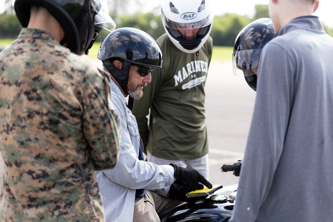 Retired U.S. Navy Chief Warrant Officer 4 Greg Wojciechowski, a Motorcycle Safety Foundation rider coach, briefs participants during a basic rider course June 25, 2026, at Marine Corps Support Facility Blount Island, Florida. The two-day course equipped novice riders with classroom instruction and hands-on training to develop rider proficiency and promote motorcycle safety. (Marine Corps photo by Dustin Senger)