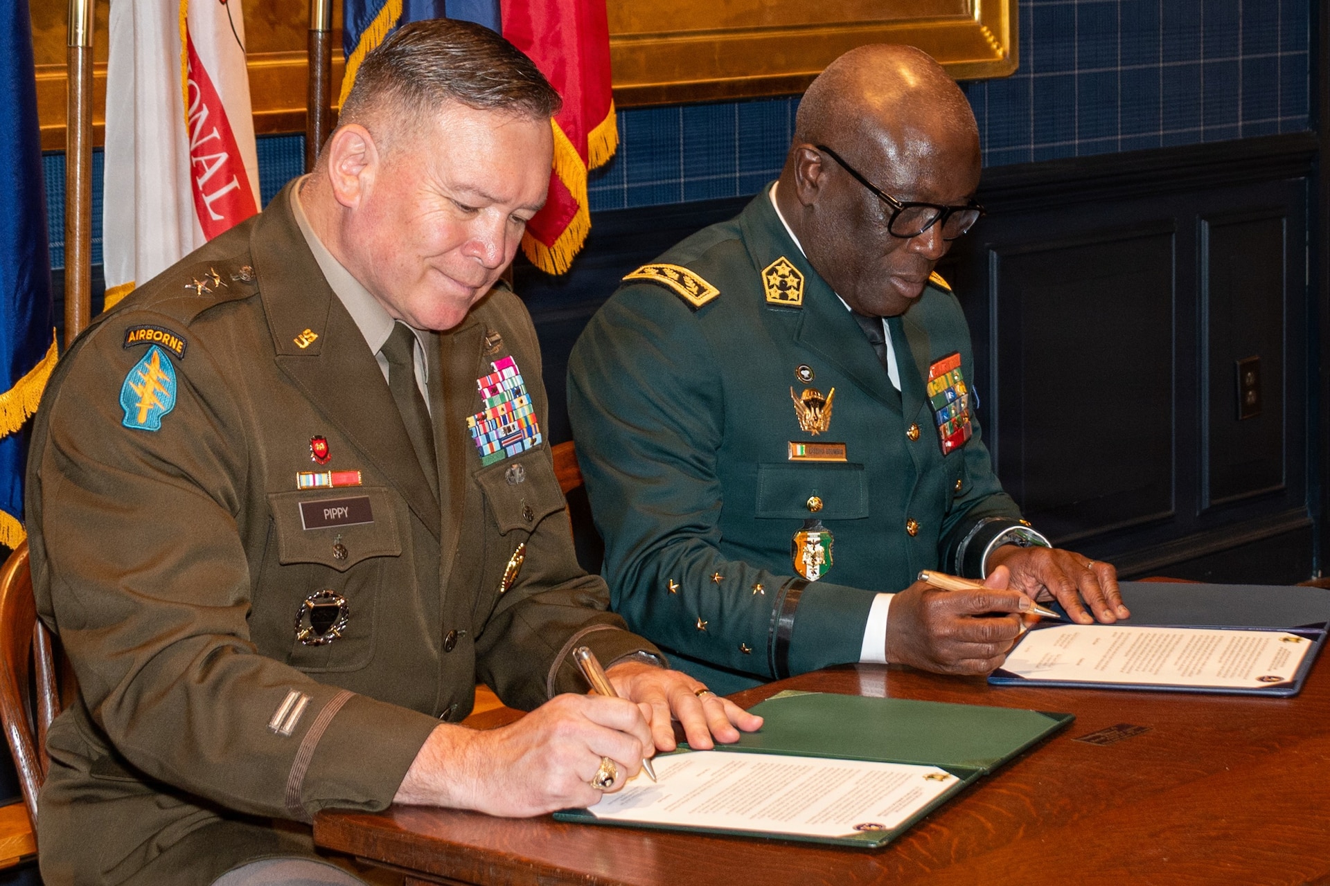 Adjutant General of Pennsylvania U.S. Army Maj. Gen. John R. Pippy and Chief of the General Staff of the Côte d'Ivoire Armed Forces Gen. Lassina Doumbia sign the official State Partnership Program agreement during a ceremony at the 23rd Street Armory in Philadelphia, June 25, 2026. The partnership focuses on sharing operational and crisis management skills while fostering indirect economic synergies between the two regions. (U.S. Army National Guard photo by Wayne V. Hall)