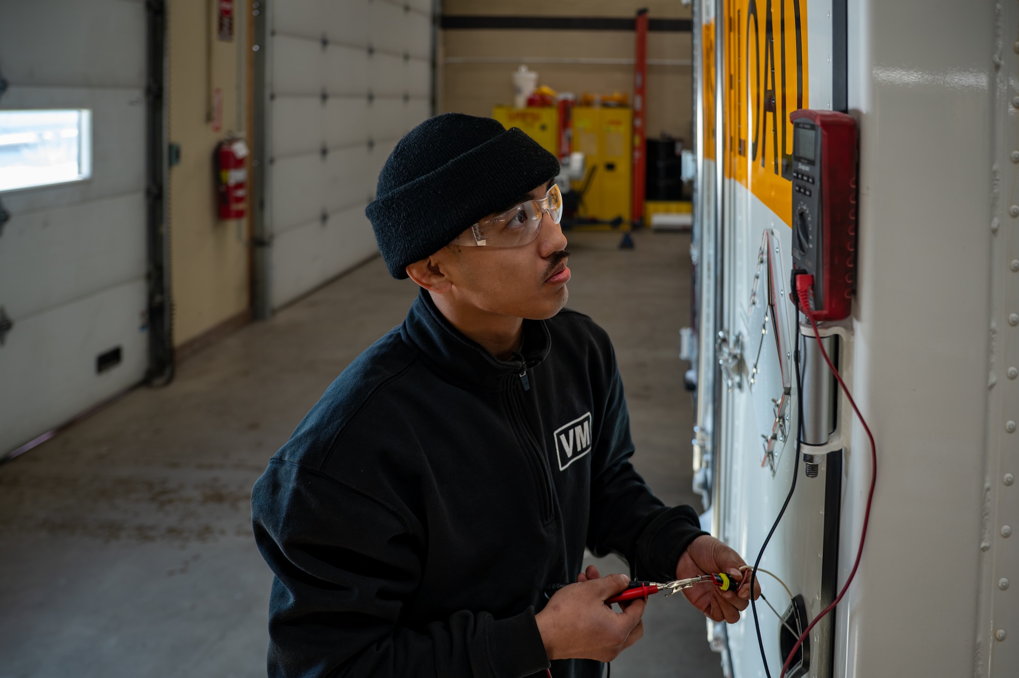 A man performs diagnostics on a vehicle.
