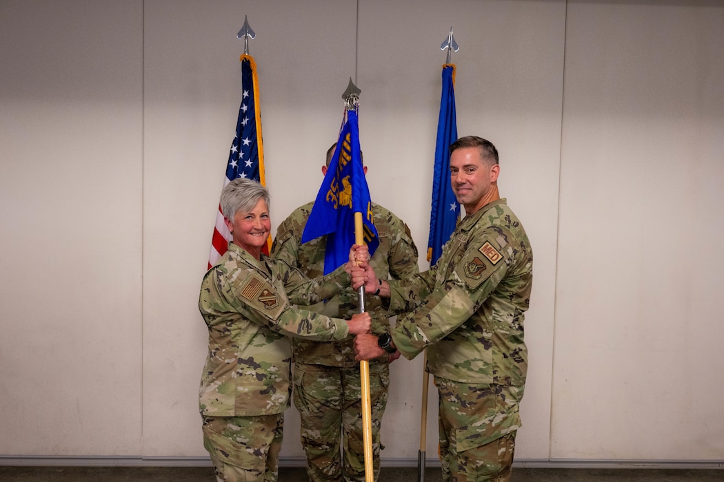 U.S. Air Force Lt. Col. Jonathan McQuaig, right, assumes command of the 354th Healthcare Operations Squadron from U.S. Air Force Col. Michele Suggs, 354th Medical Group commander, during an assumption of command ceremony at Eielson Air Force Base, Alaska, June 23, 2026.
