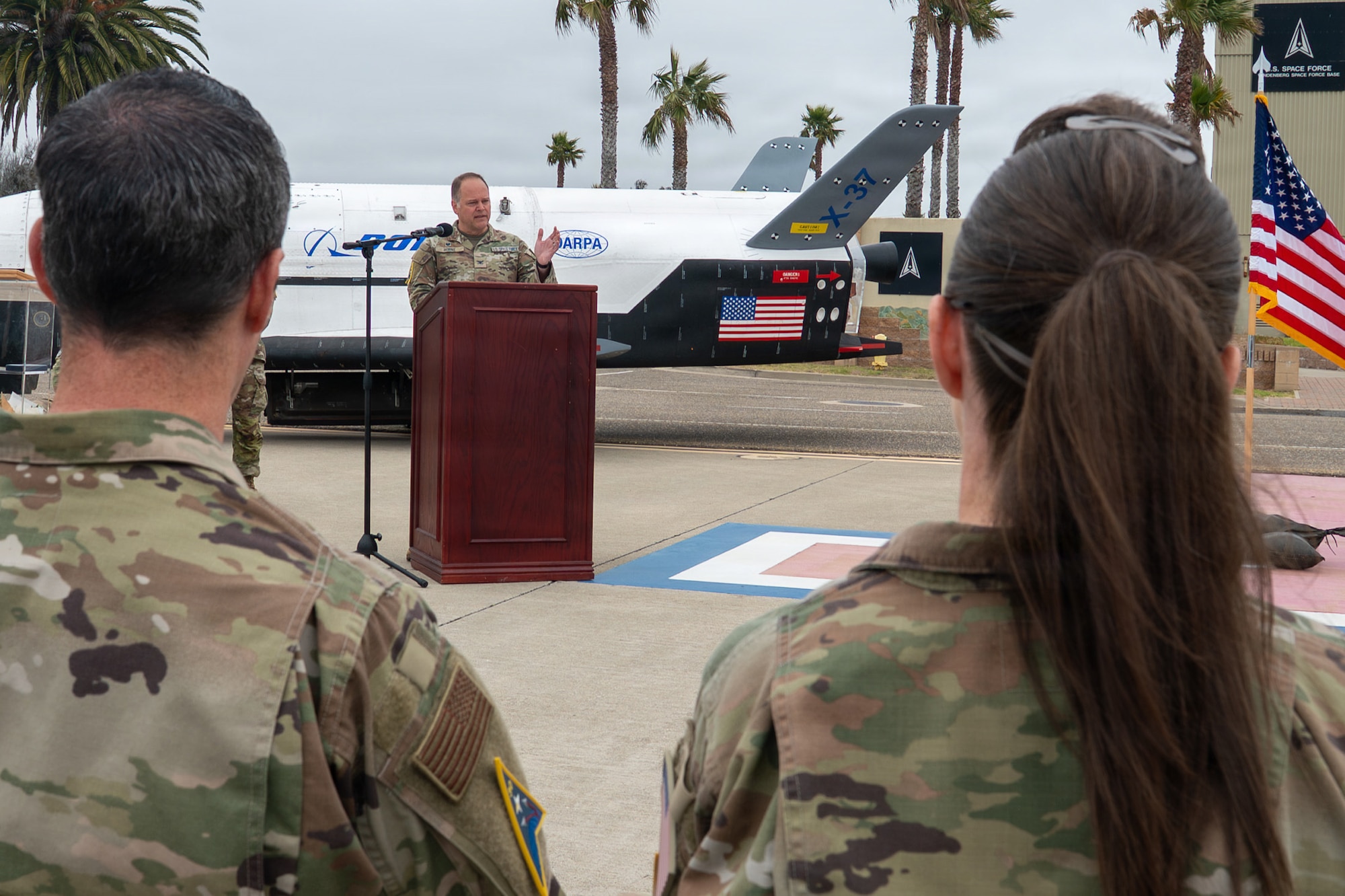 A person speaks and stands behind a podium