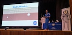 Following his presentation to a packed King Hall at the Naval Postgraduate School (NPS), NASA Artemis II pilot U.S. Navy Capt. Victor Glover welcomed a sea of youngsters to the front of the auditorium for a group photo. An NPS alumnus, Glover shared stories of his historic voyage around the Moon as well as his journey to becoming a naval aviator, test pilot, and astronaut during a Secretary of the Navy Guest Lecture, June 16, 2026. (U.S. Navy photo by Mass Communication Specialist Second Class Janiel Adames)