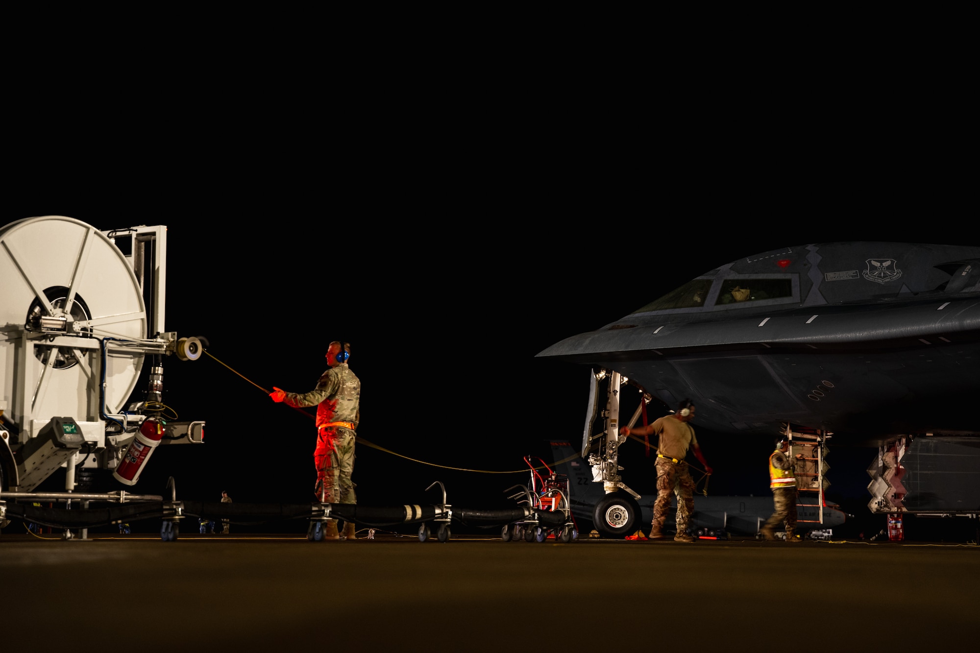 U.S. Airmen assigned to the 393rd Expeditionary Bomb Squadron conduct hot-pit refueling operations for a B-2 Spirit aircraft as part of a Bomber Task Force deployment at Royal Australian Air Force Base Amberley, Queensland, Australia, June 11, 2026.