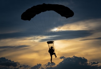 A U.S. Air Force C-130J Super Hercules assigned to the 36th Airlift Squadron, releases U.S. Navy personnel during an airborne training at Yokota Air Base, Japan, June 22, 2026. The training provided an opportunity to improve readiness, refine airborne operations and reinforce partnerships between U.S. military services.