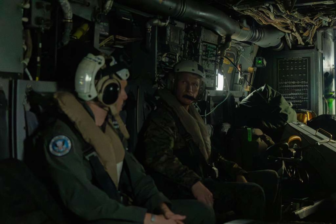 A military person boards a military aircraft.