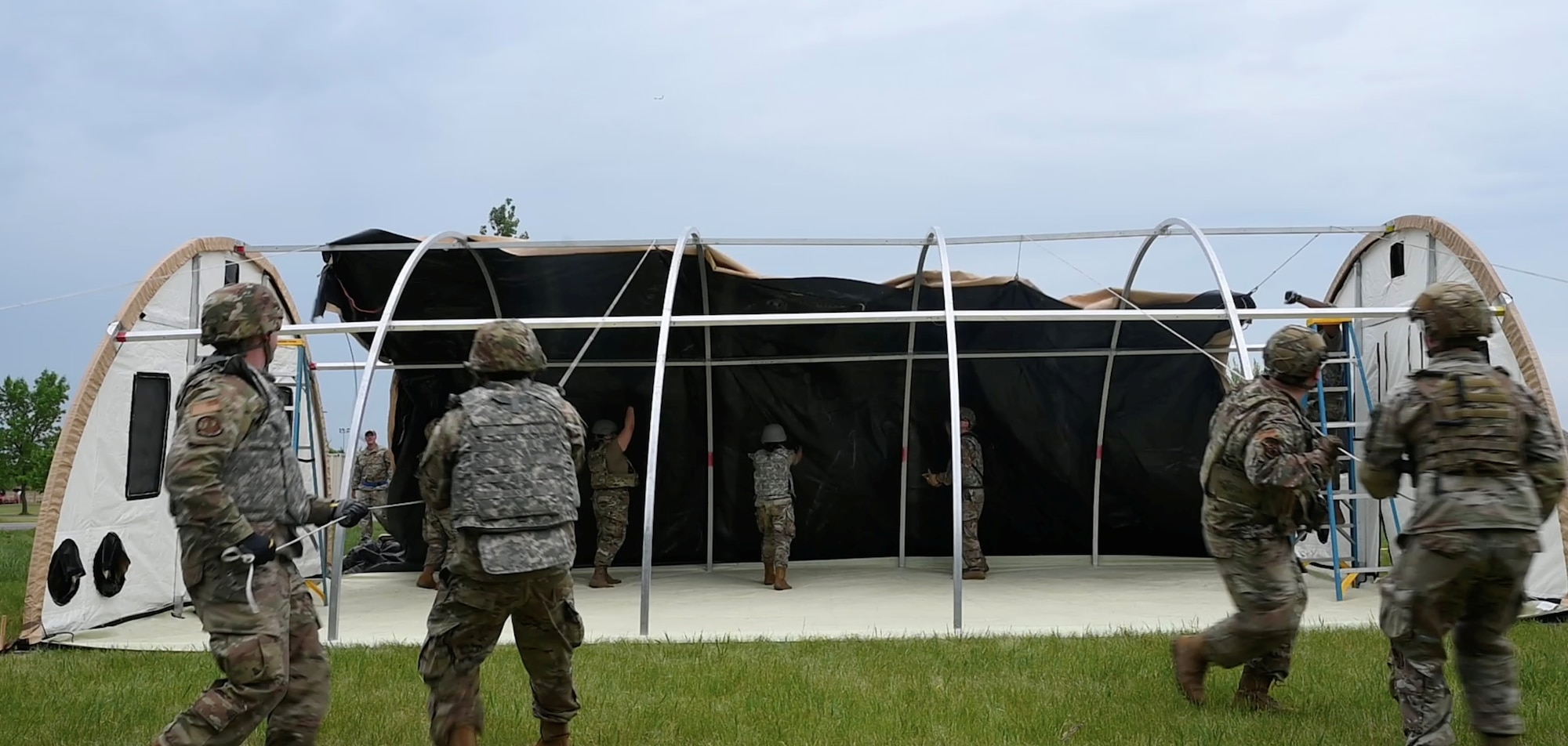 Airmen assigned to structures, 5th Civil Engineering squadron pull the top onto a small shelter system (sss) during the bivouac exercise at Fargo Air National Guard Base, North Dakota, May 31, 2026. The sss is a highly durable, modular, and climate-controlled tent built to handle extreme environments.