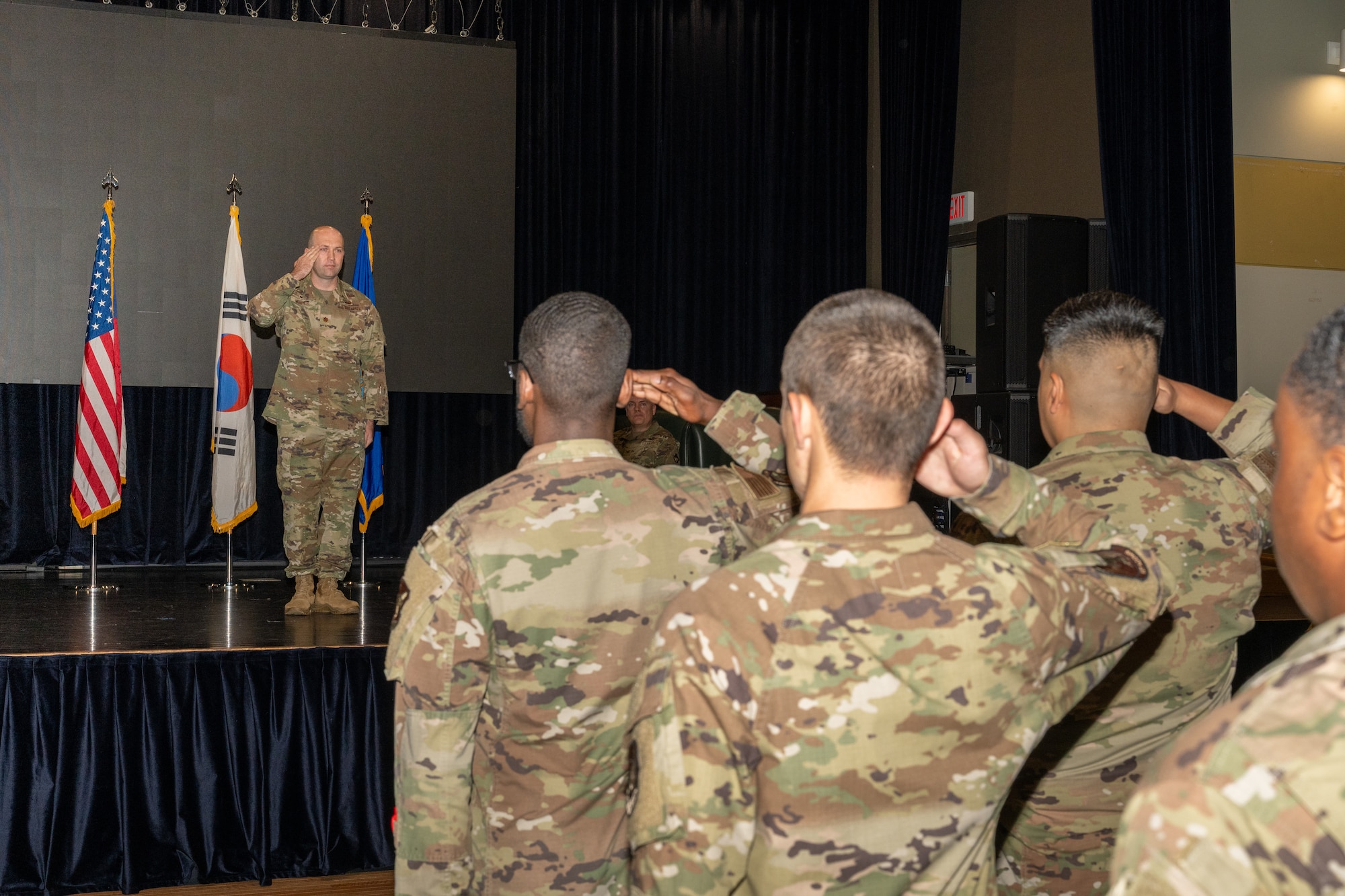 A commander salutes Airmen after accepting command during a ceremony.