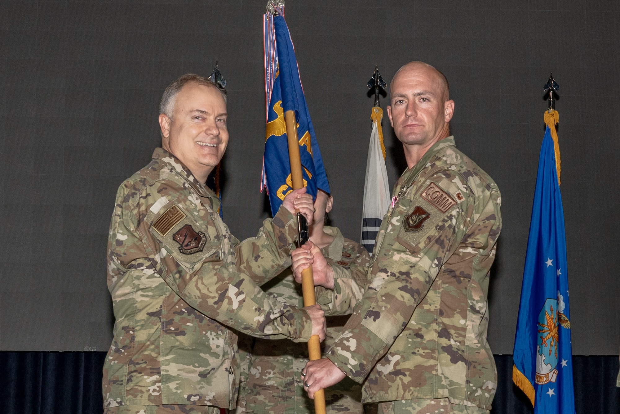 A commander relinquishes command of a squadron during a ceremony.