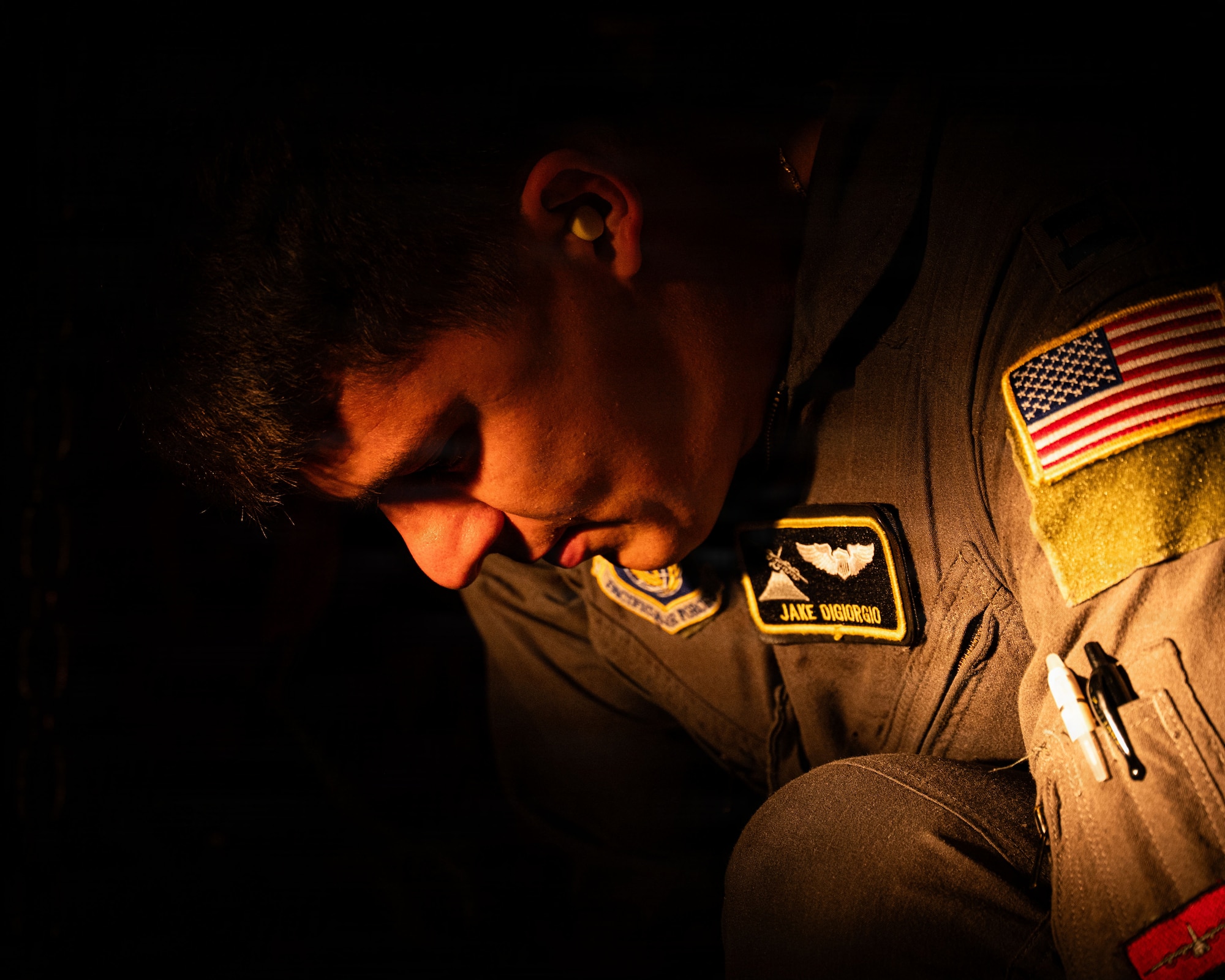 A servicemember strap down a military vehicle