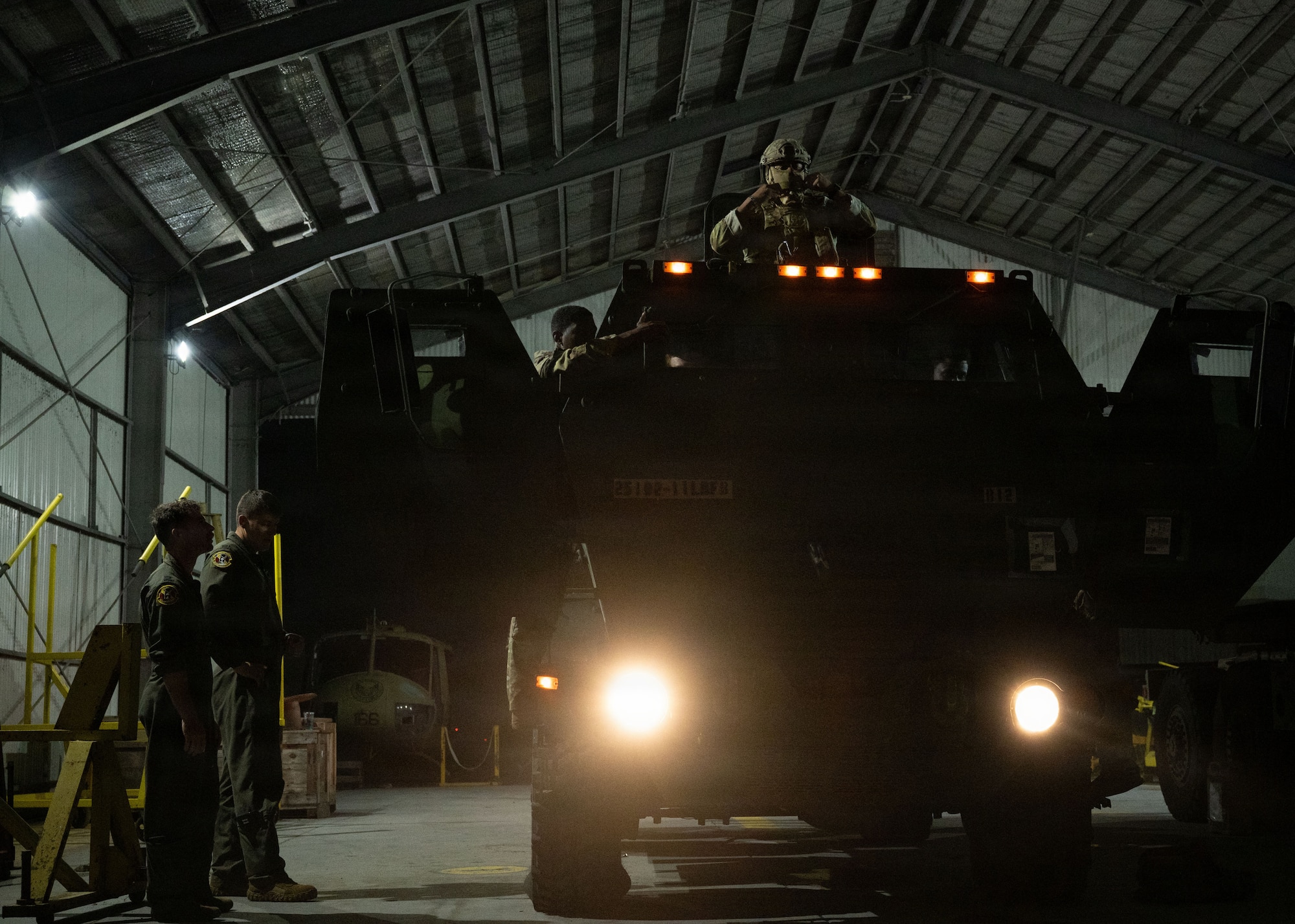 A military vehicle stands static at night