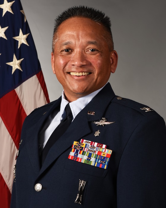 A man stands for an Air Force official photo.