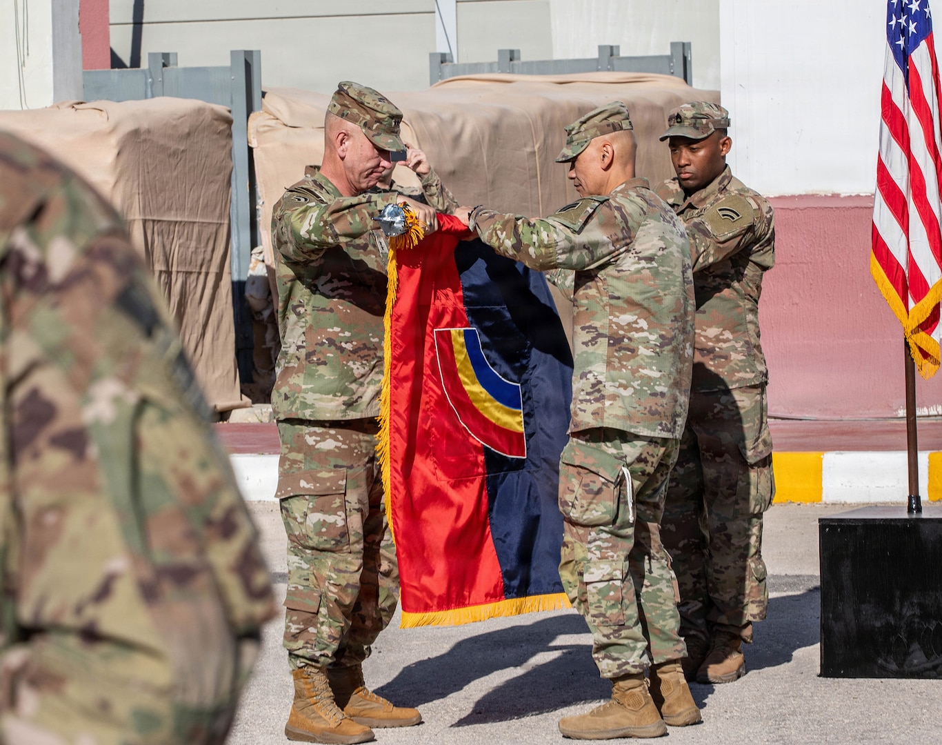 Maj. Gen. Jack James, left, and Command Sgt. Maj. Arnold Reyes, right, the 42nd Infantry Division command team, case the division's colors during the Task Force Spartan transfer of authority ceremony June 6, 2026, in the Middle East.