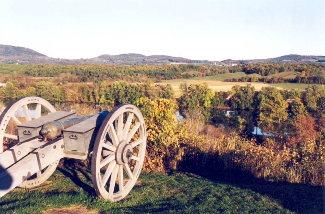 A canon is placed at the edge of a hill.
