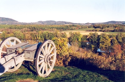 A canon is placed at the edge of a hill.
