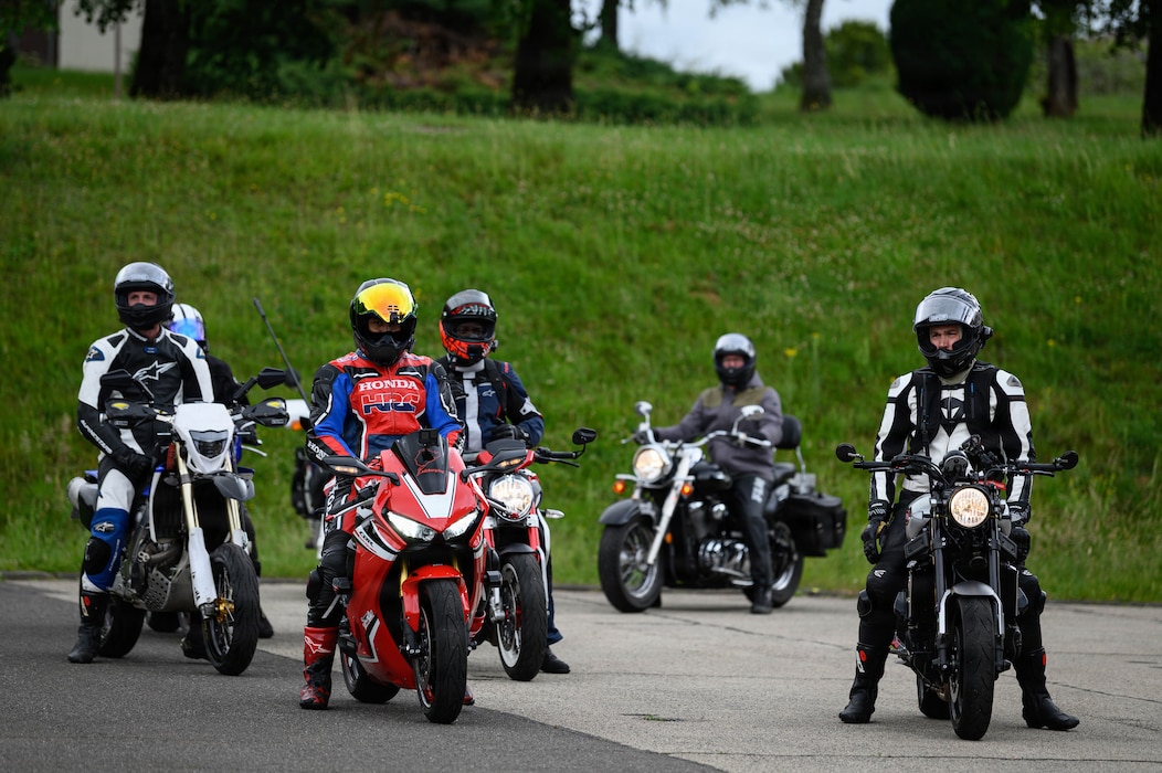 Several people sit on motocycles.