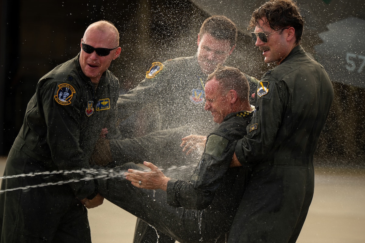 U.S. Air Force Col. Christian Bergtholdt, 325th Fighter Wing commander, is sprayed with water following his fini flight at Tyndall Air Force Base, Florida, June 22, 2026. The fini flight is a military aviation tradition marking a pilot's departure from a unit, commemorating Bergtholdt's two-year tenure leading the wing. (U.S. Air Force photo by Senior Airman Amanda Alvarez)