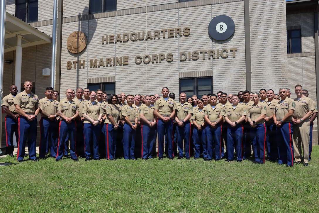 U.S. Marine Corps Sgt. Maj. Carlos A. Ruiz, the 20th Sergeant Major of the Marine Corps, poses with the Marines and Sailors of 8th Marine Corps District (8MCD) aboard Naval Air Station JRB, Fort Worth, Texas, on May 14, 2026. During his visit, Ruiz learned about the different roles and responsibilities of each section and met recruiters across 8MCD. (U.S. Marine Corps photo by Lance Cpl. Ayusha Shrestha)