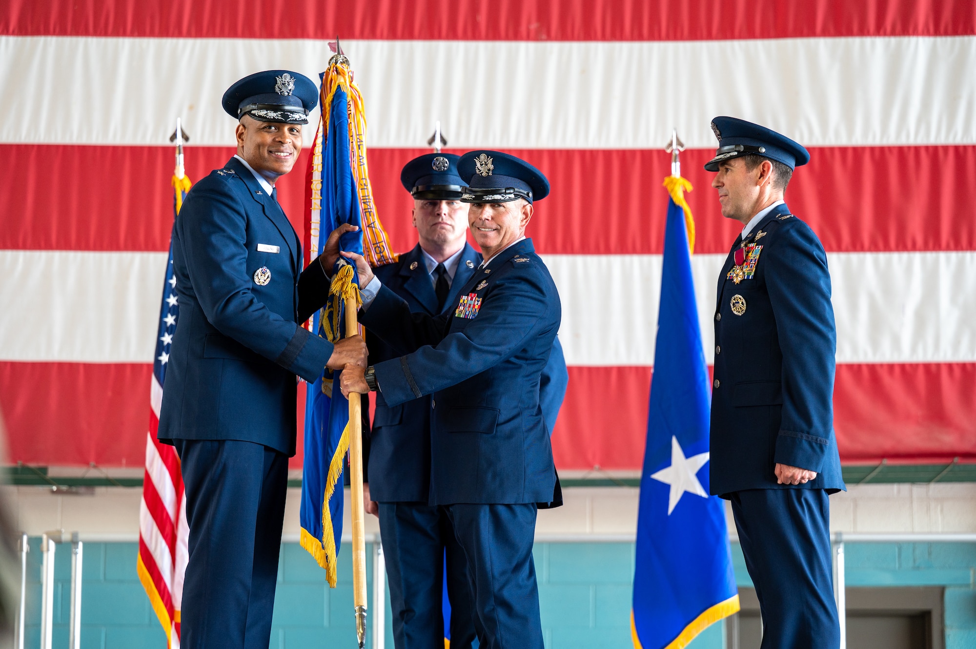 U.S. Air Force Col. Jeff McMaster, incoming 58th Special Operations Wing commander, receives the wing guidon from Maj. Gen. Roy W. Collins, Deputy Commander of Air Education and Training Command, during a change of command ceremony at Kirtland Air Force Base, New Mexico, June 24, 2026. The passing of the guidon is a traditional military ritual symbolizing the transfer of total authority and responsibility of the wing from the outgoing commander, Col. Jason Allen, to the incoming commander. (U.S. Air Force photo by Senior Airman Donnell Schroeter)