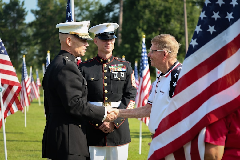 Maj. Gen. Keith D. Reventlow, commanding general, Marine Corps Logistics Command, and Sgt. Maj. Marshall H. Gregg, senior enlisted advisor, MARCORLOGCOM, speak with leadership from the Exchange Club of Lee County following the Field of Honor opening ceremony at the Oakland Library in Leesburg, Georgia, June 26, 2026. The annual display provides a visible tribute to patriotism, service and sacrifice.