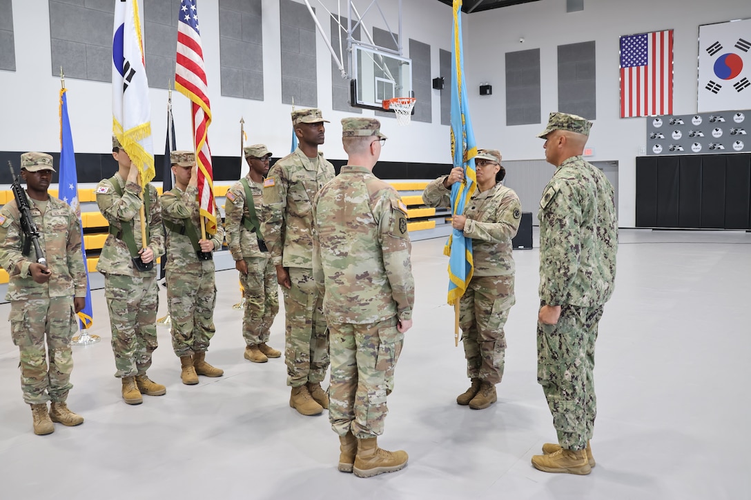 An Army officer hold her unit's guidon during a change of command ceremony.