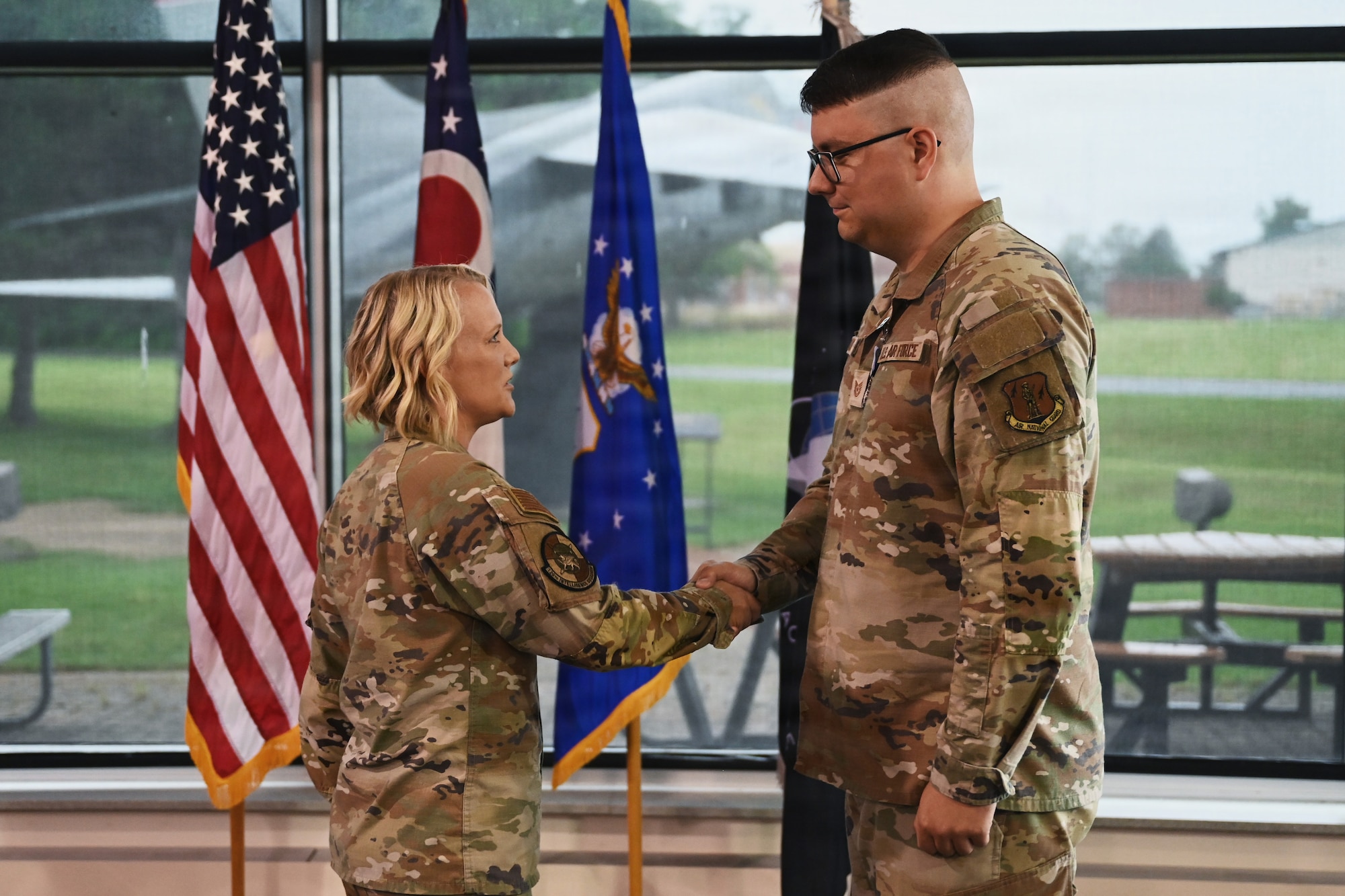 U.S. Air Force Lt. Col. Britney Hensley, commander of the 126th Intelligence Squadron, bids farewell to Tech. Sgt. Dylan Jacques, an intelligence analyst assigned to the 126th IS at Springfield-Beckley Air National Guard Base, who transferred to the 76th Intelligence, Surveillance and Reconnaissance Squadron in a historic ceremony June 26, 2026. This marks the first time an Airman in the Air National Guard has been authorized to transfer to the Space Force without completing their existing service commitments to the Guard. (U.S. Air National Guard photo by Shane Hughes)